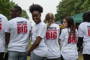 group of people with big local t shirts