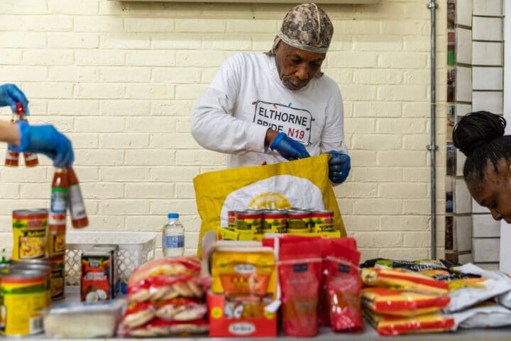Volunteer at Elthorne Pride packs food bags