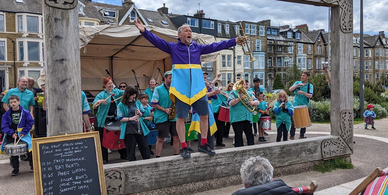 Brass band playing to an audience in West End, Morecambe