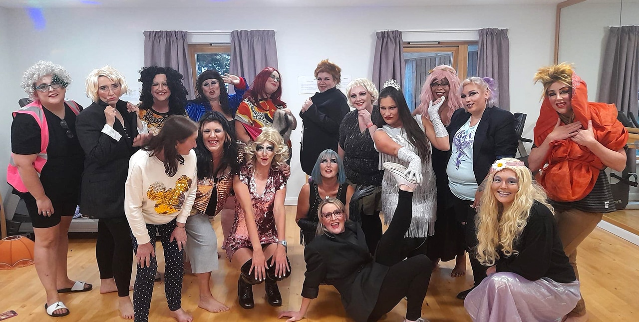 Participants in the Screaming Mary group posing in burlesque and drag 