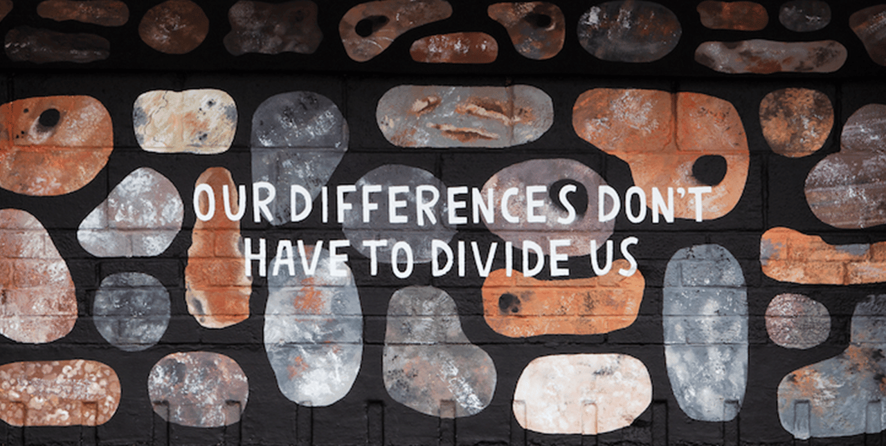 Mural with the words 'Our differences don't have to divide us'