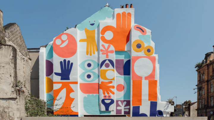 An abstract mural painted on the side of a house