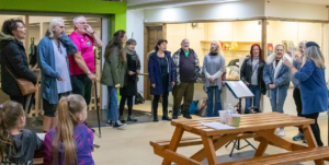 A group of people across various ages singing in a choir.