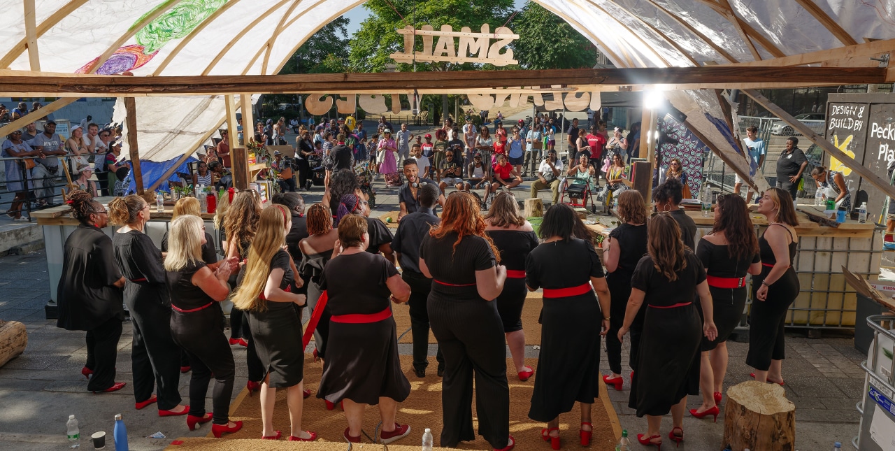 The back of a group performing to an audience