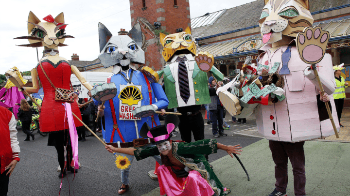 Image of the carnival, with performers wearing cat costumes