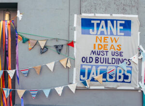 Sign reading 'New ideas must use old buildings'