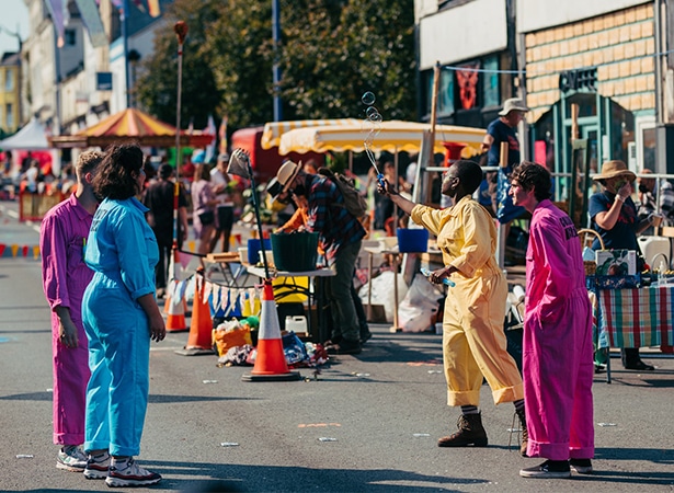 People dance in the street.