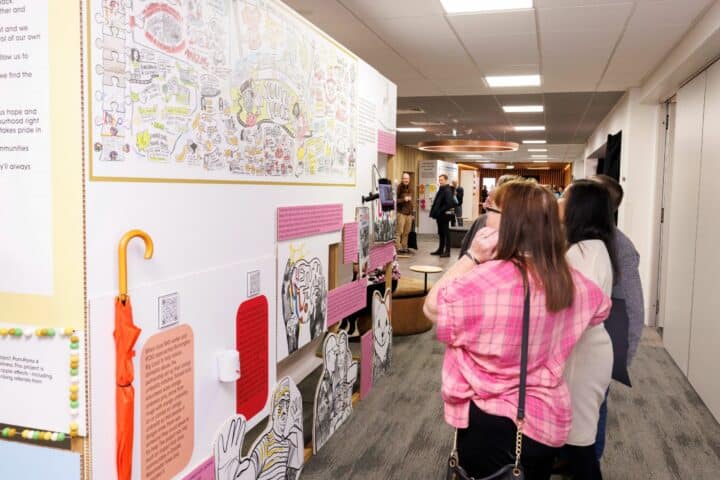 Attendees of Big Local connect examine wall displays