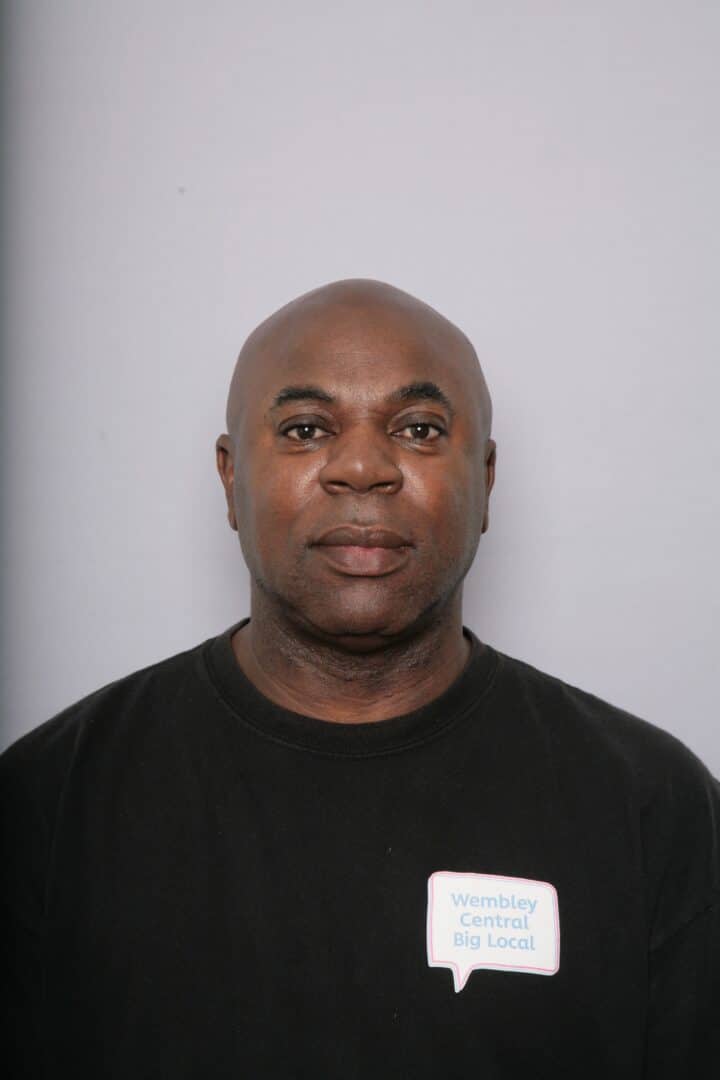 Junior Collins profile image looking at camera with white background wearing a Big Local T shirt.