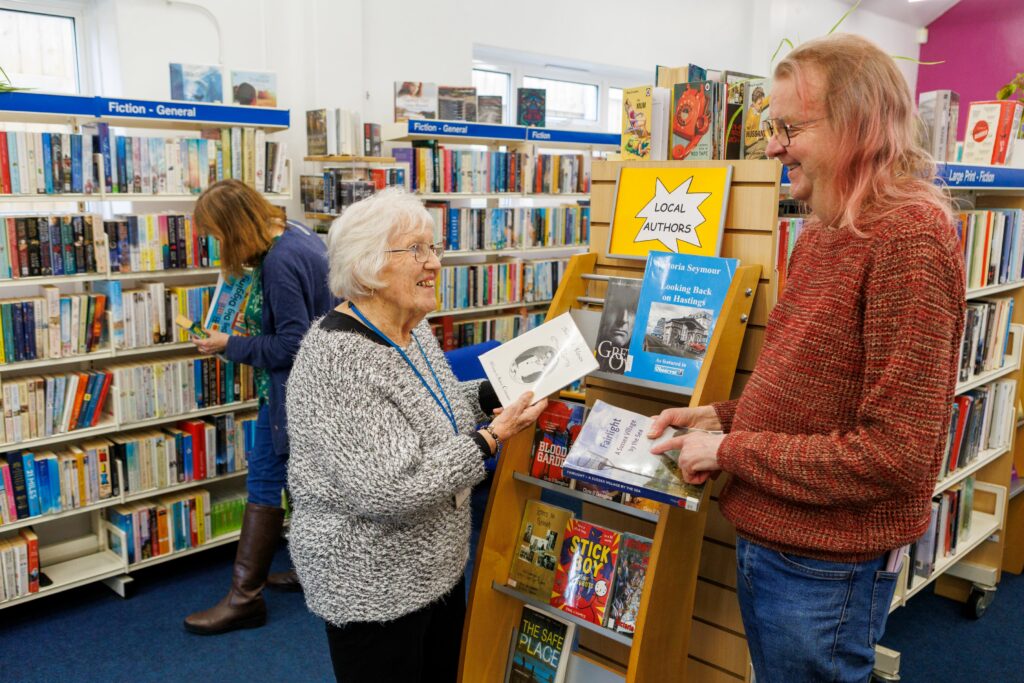 Two volunteers working in community library