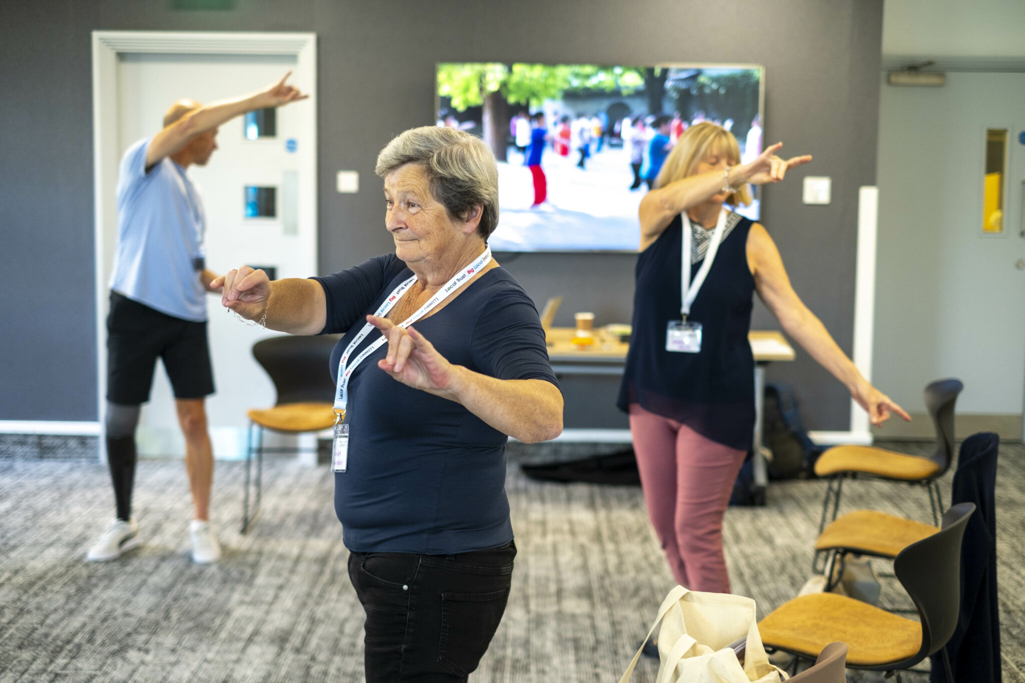 Three people in an exercise class at a conference