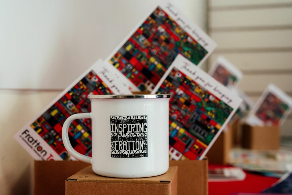 White mug that reads inspiring fratton