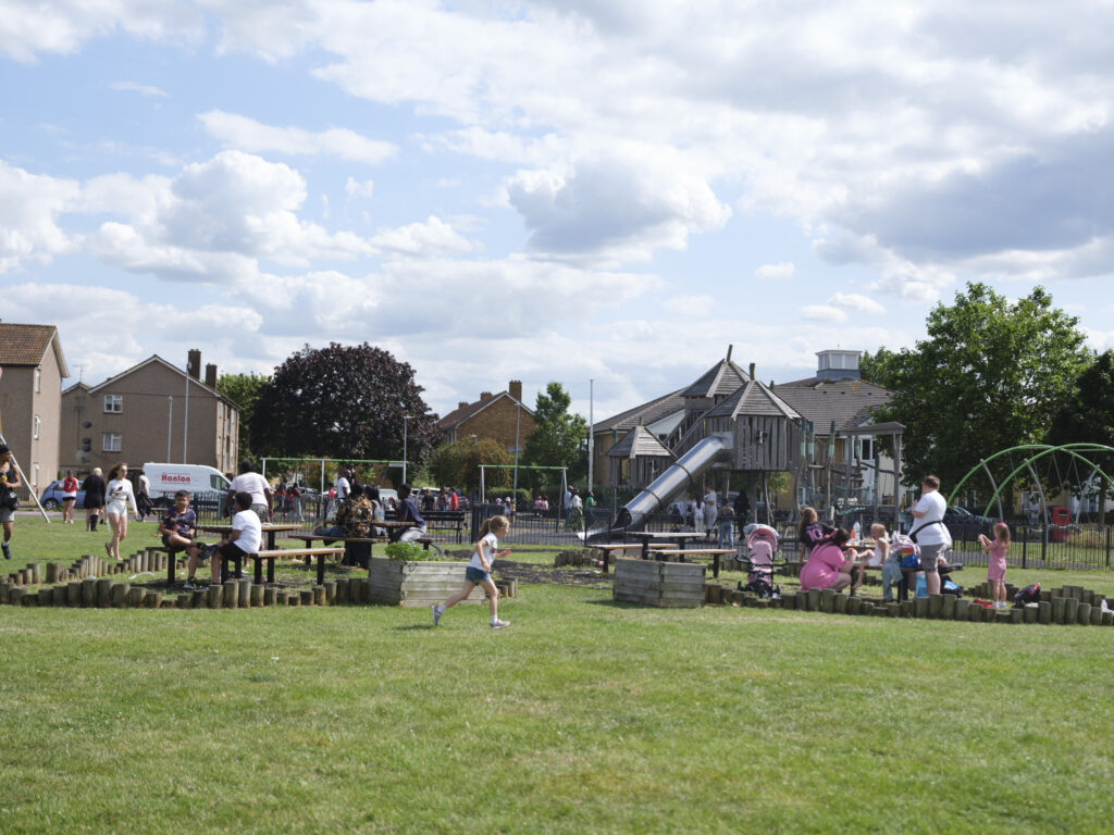 A busy playground and picnic benches