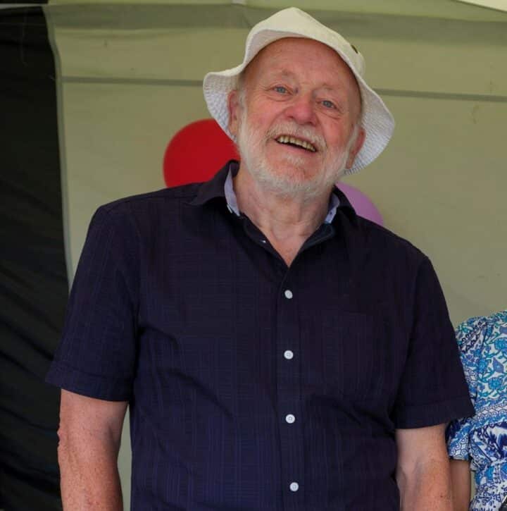 Roy Figes wearing a white hat and navy shirt