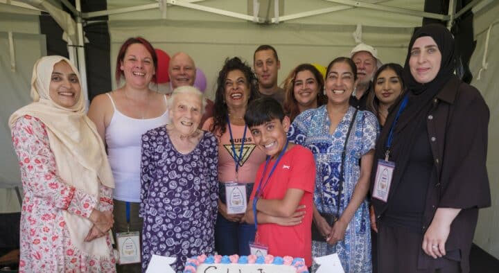 Group of people gathered together and they are smiling at the camera