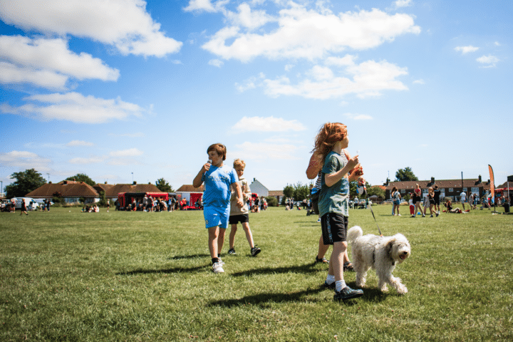 Children eat ice cream at the Sompting Big Local summer event in 2024