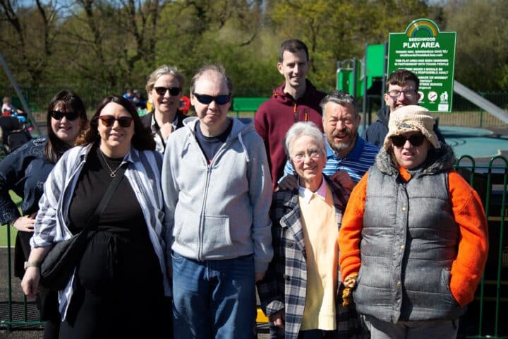 A group of adults standing and smiling for a photo
